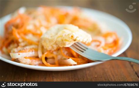 marinated fish wih carrot on wooden background