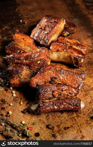Marinated fried pork ribs with spices, garlic and cumin. Vertical shot.