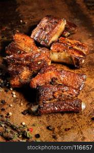Marinated fried pork ribs with spices, garlic and cumin. Vertical shot.