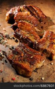 Marinated fried pork ribs with spices, garlic and cumin. Vertical shot. View from above.