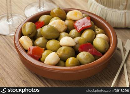 Marinated green olives and garlic as a snack