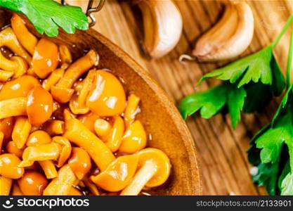 Marinated mushrooms with cloves of garlic. Macro background. Top view. High quality photo. Marinated mushrooms with cloves of garlic.