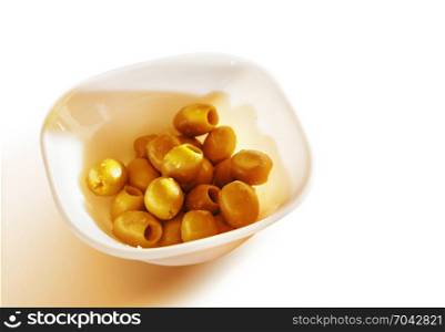 marinated olives in teabowl on white background