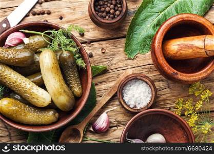 Marinated pickled cucumbers.Pickled cucumbers with herbs and spices.Ingredients for cooking pickled cucumbers. Homemade Pickles On Wooden Table