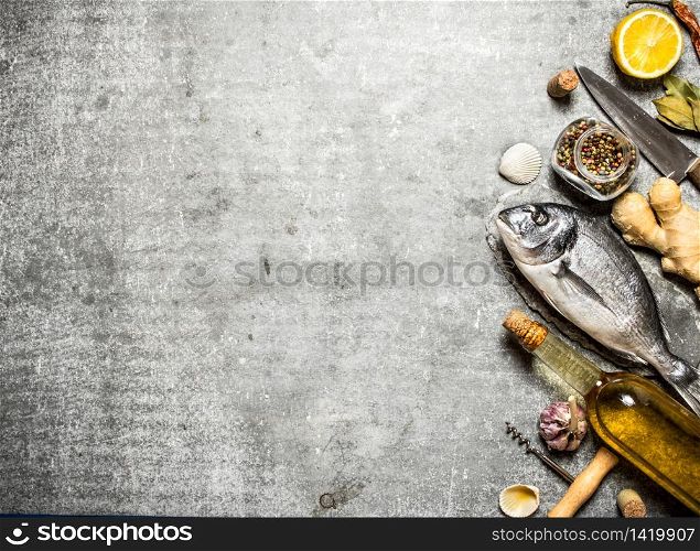 Marine fish with wine and a variety of spices and herbs. On a stone background. Marine fish with wine