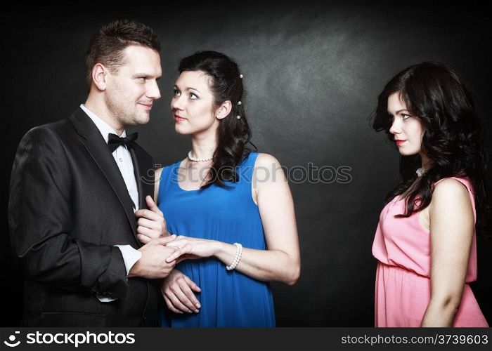 marital infidelity concept. Love triangle two women one man passion of love hate. Mistress betrayal within the family. Black background
