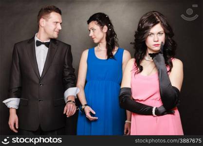 Marital infidelity concept. Love triangle two women one man passion of love hate. Mistress betrayal within the family. Black background.