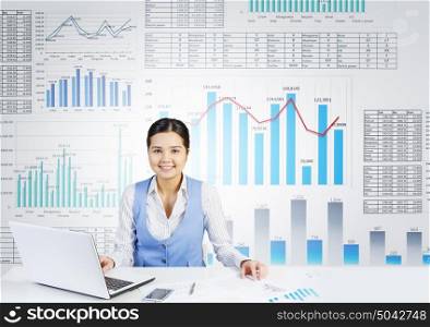 Market analysis and report. Businesswoman at table working on laptop and infographs at background