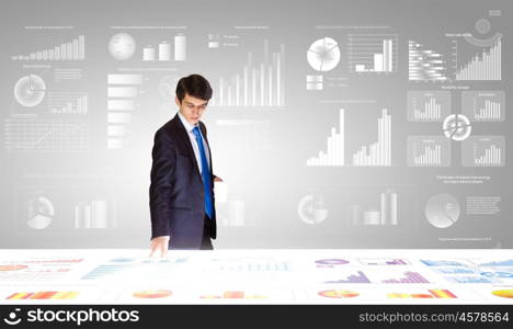 Market business. Young businessman and statistics information at background