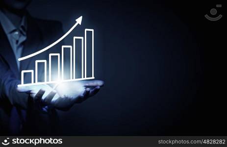 Market graphs. Close up of businesswoman holding market infographs in hands