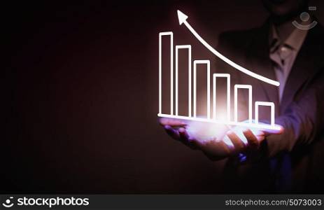 Market graphs. Close up of businesswoman holding market infographs in hands