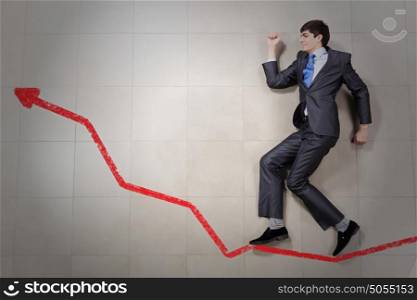 Market growth. Young businessman running on increasing graph. Growth concept
