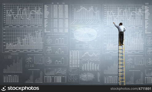 Market infographs. Back view of businessman standing on ladder and drawing sketch on wall