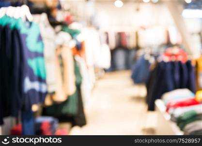 Market shop and supermarket interior in clothes section as blurred store background