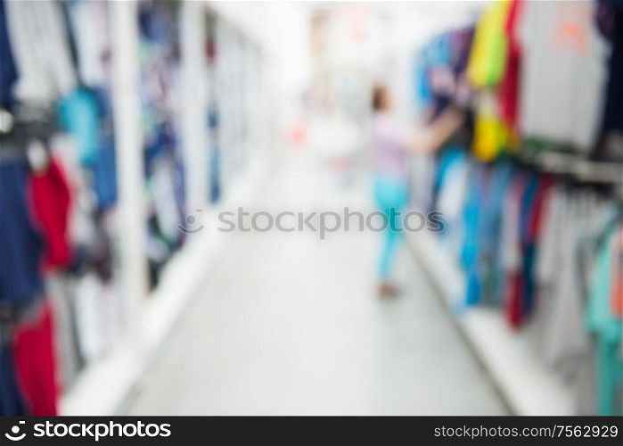 Market shop and supermarket interior in clothes section as blurred store background