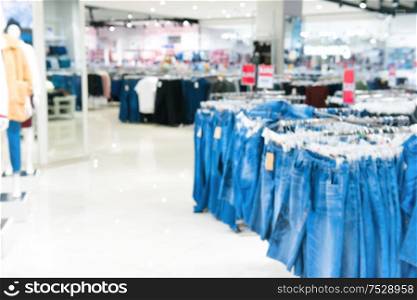 Market shop and supermarket interior in jeans section as blurred store background