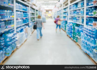 Market shop and supermarket interior with drink water section as blurred store background