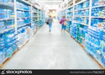 Market shop and supermarket interior with drink water section as blurred store background