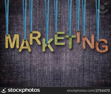 Marketing Letters hanging strings with blue sackcloth background.. Marketing