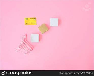 Marketing strategy or loan concepts from credit card and product box on pink background. Top view
