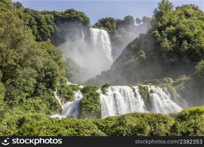 Marmore waterfall in Umbria region, Italy. Amazing cascade splashing into nature with trees and rocks.