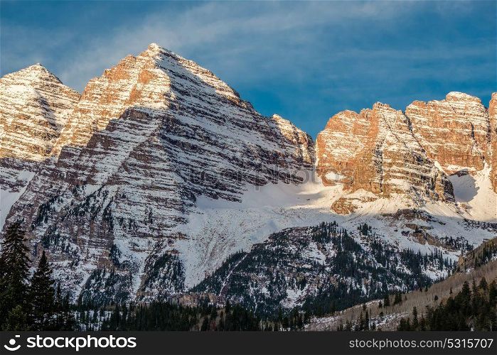 Maroon Bells mountains in snow at morning in Colorado, USA.