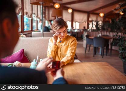 Marriage proposal with wedding ring to beautiful woman at luxury restaurant. Couple romantic date