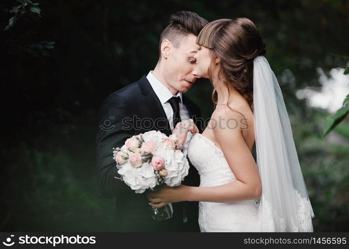 Married couple angry quarreling and fighting. fun and crazy brides. Bride and groom have fun walking across the green field along.. Married couple angry quarreling and fighting. fun and crazy brides. Bride and groom have fun walking across the green field along