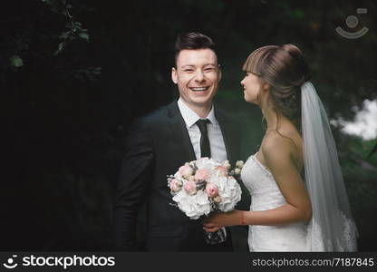 Married couple angry quarreling and fighting. fun and crazy brides. Bride and groom have fun walking across the green field along.. Married couple angry quarreling and fighting. fun and crazy brides. Bride and groom have fun walking across the green field along