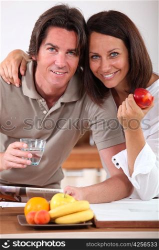Married couple having breakfast in kitchen