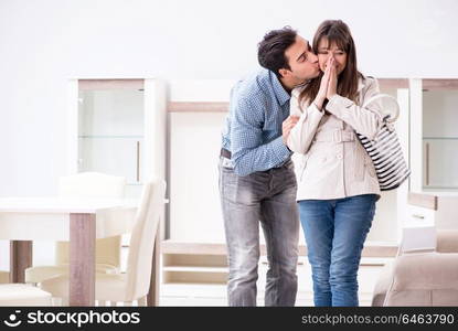 Married couple in the shop choosing furniture