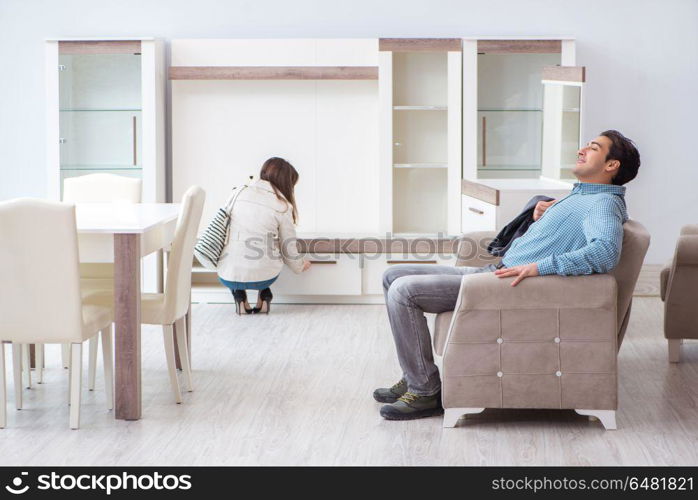 Married couple in the shop choosing furniture