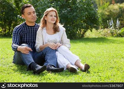 married couple looking aside outdoors