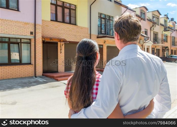 married couple looking at their new home