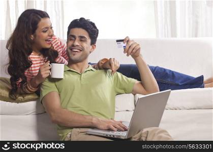 Married couple with credit card and laptop