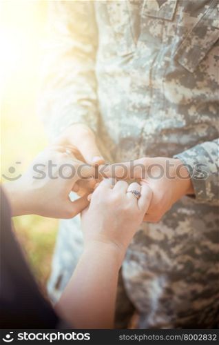 Married military couple holding hands