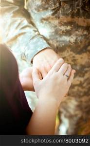 Married military couple holding hands