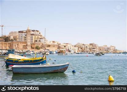 Marsaskala city and bay with typical boats, Malta