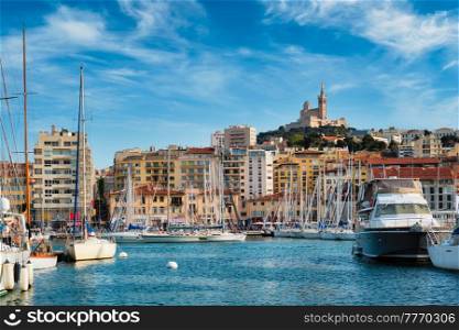 Marseille Old Port (Vieux-Port de Marseille) with yachts and Basilica of Notre-Dame de la Garde. Marseille, France. Marseille Old Port with yachts. Marseille, France