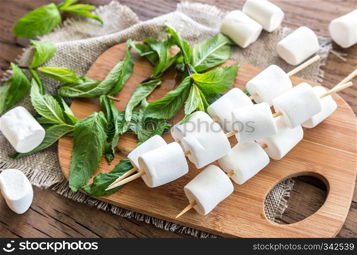 Marshmallow skewers on the wooden board