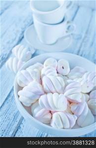 marshmallows in bowl and on a table