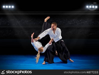 Martal arts fighters in sports hall