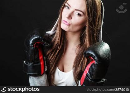 Martial arts or self defence concept. Sport boxer woman in gloves. Fitness girl training kick boxing on black background