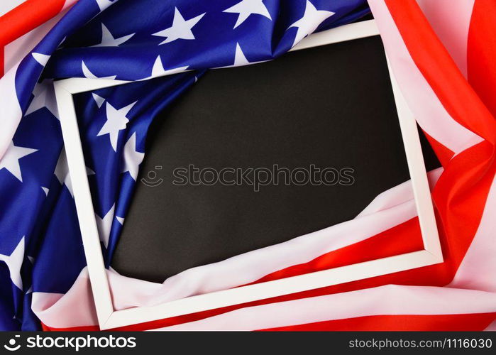 Martin luther king day, flat lay top view, American flag and photo frame on black background with copy space for your text