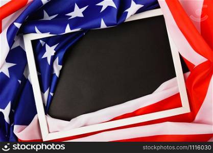 Martin luther king day, flat lay top view, American flag and photo frame on black background with copy space for your text