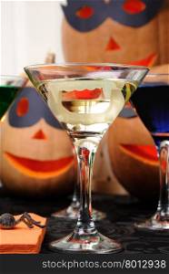 martini vampire with jaws in a glass on the table in honor of Halloween