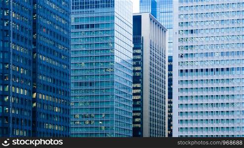Marunouchi District modern office buildings Tokyo downtown cityscape in evening with offices light on. Japan