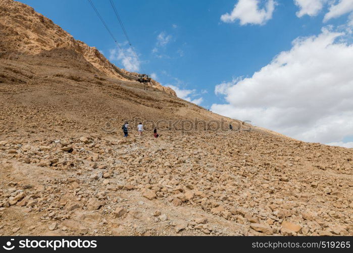 Masada,Israel,26 march 2019:people walking all the 800 steps to masada mountain in israel. people walking to masada mountain