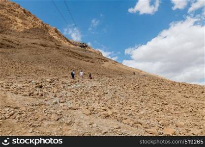 Masada,Israel,26 march 2019:people walking all the 800 steps to masada mountain in israel. people walking to masada mountain