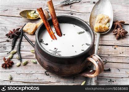 Masala tea in cup. indian Masala tea in clay cup with spices on retro background